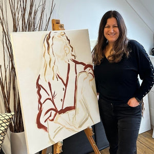 Elise Mendelle is a london-based artist, she is stood next to three of her paintings hanging in a gallery space.