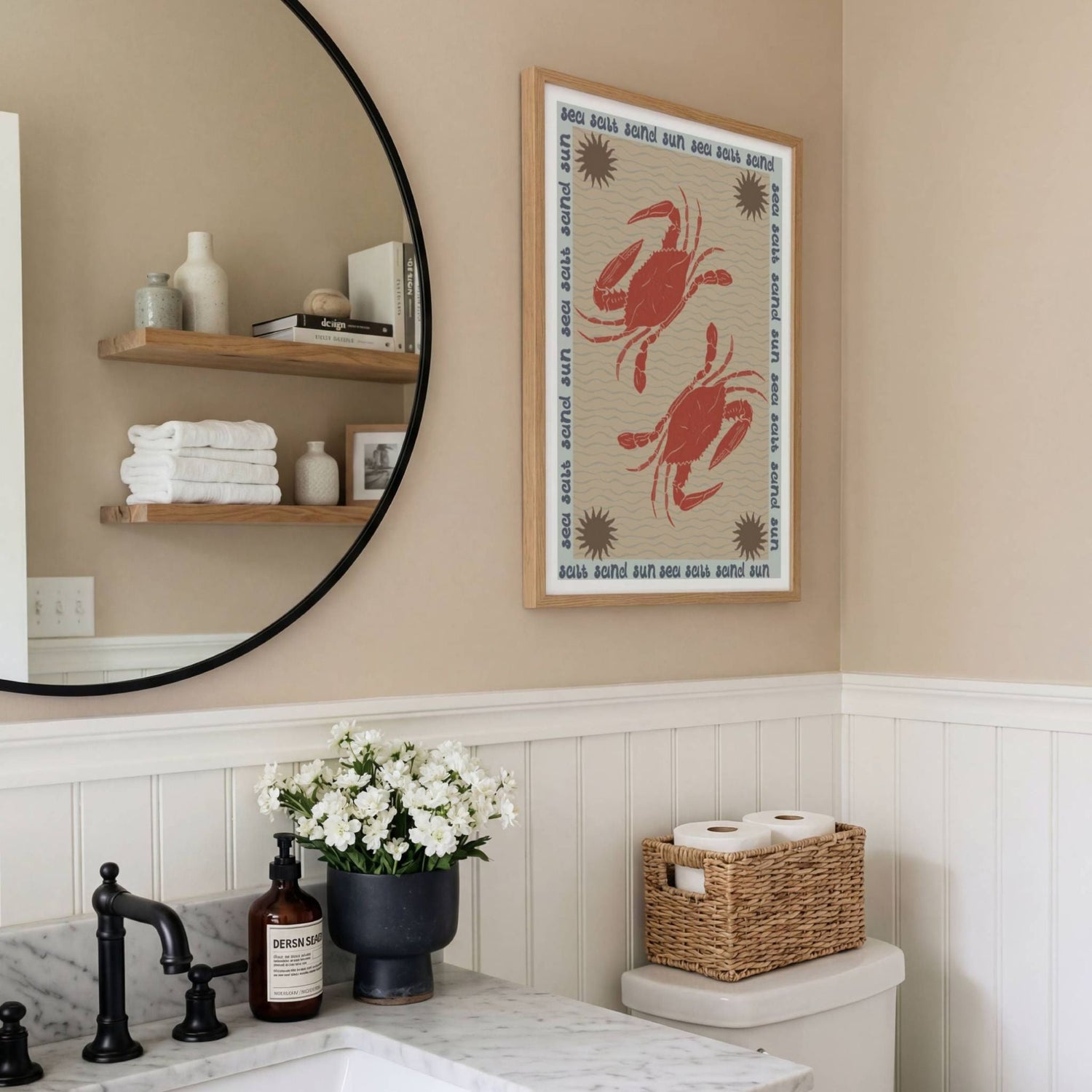 Framed art print of two crabs in a neutral coloured modern bathroom. Print is in a wooden frame hung on the wall next to a bathroom mirror.