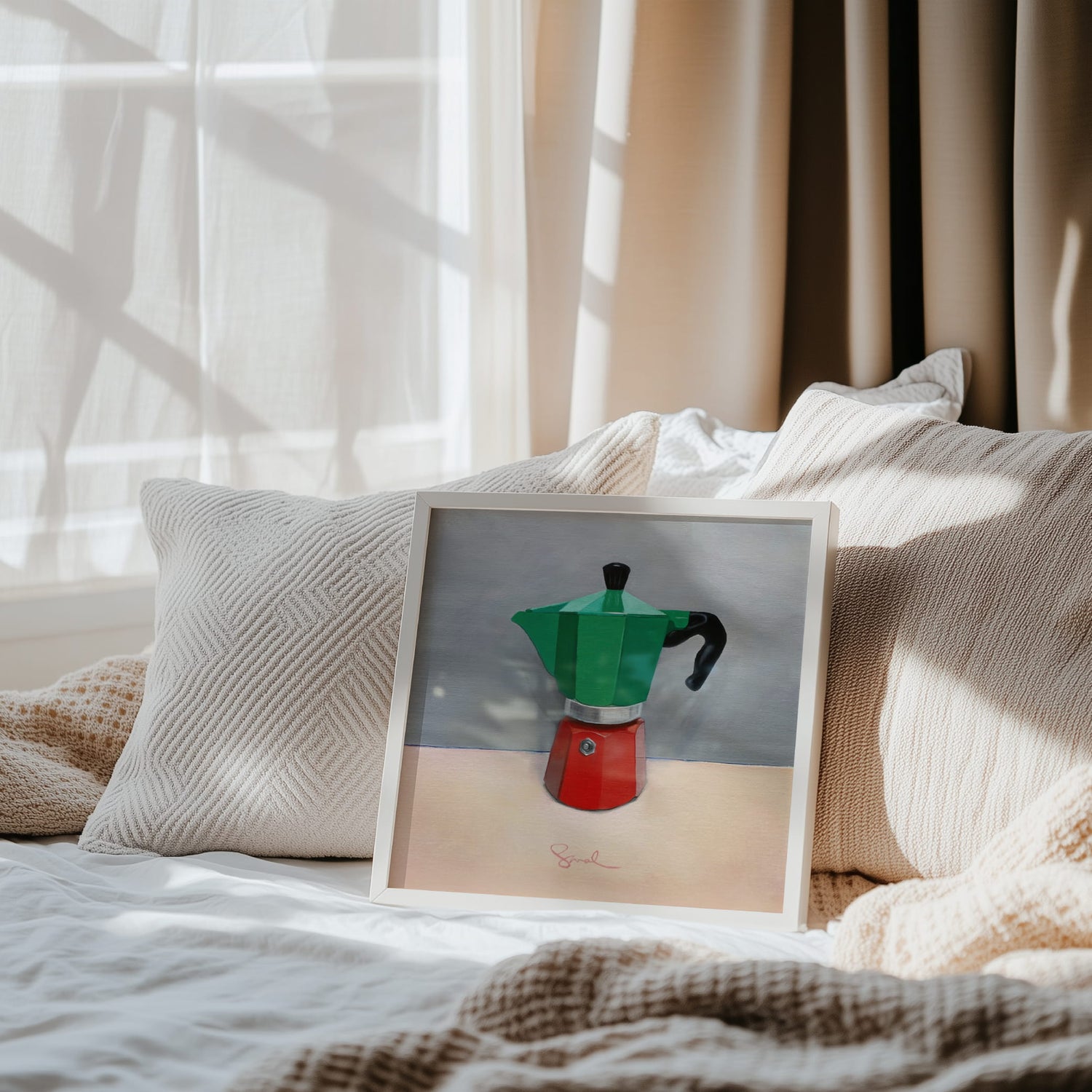 Calm neutral bedroom scene with an art print of a coffee pot resting against the pillows of a bed. Dappled light is coming through the window and the bedroom is calm and inviting. 
